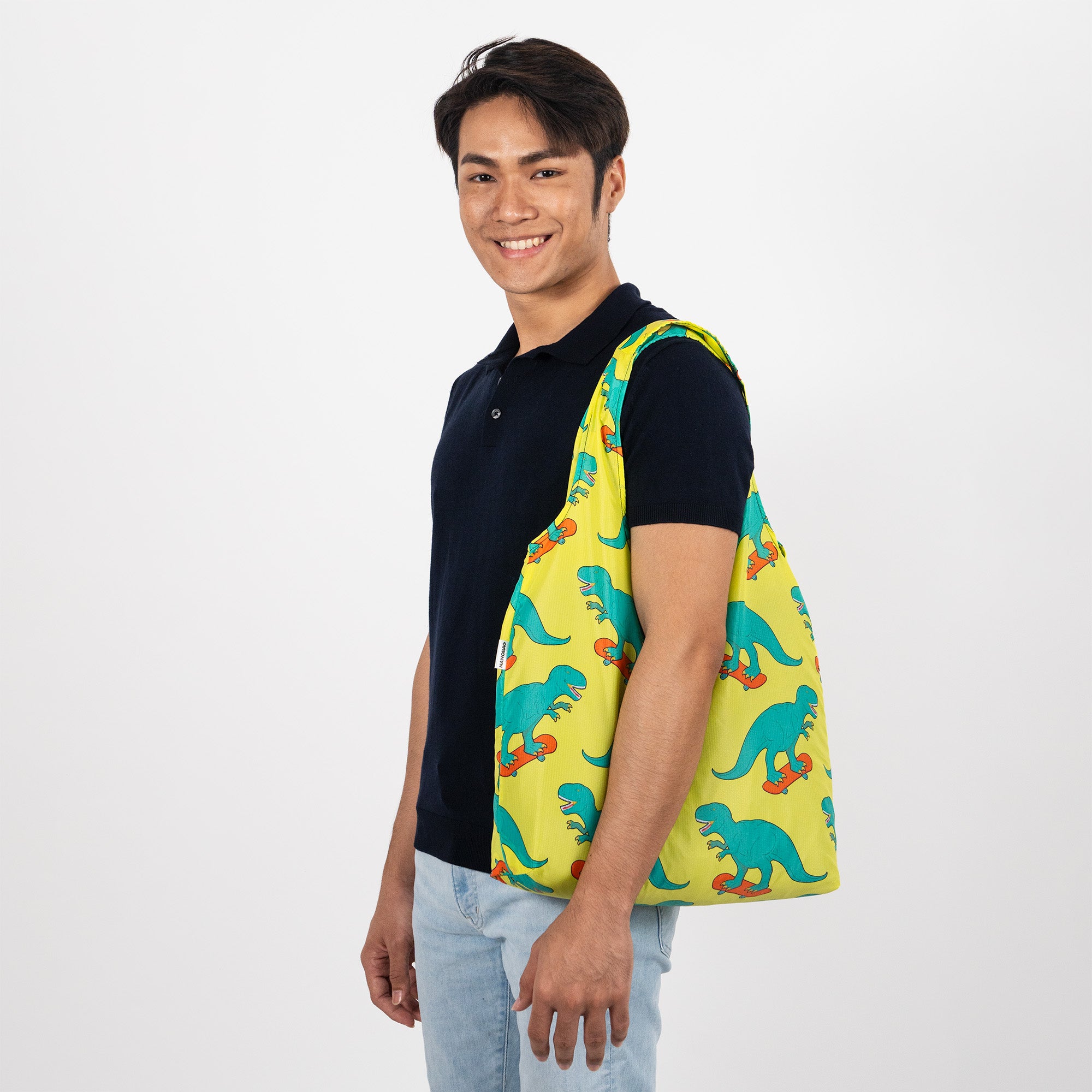 Man with yellow dinosaur tote bag